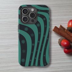 an iphone case sitting on top of a wooden table next to fruit and spices,