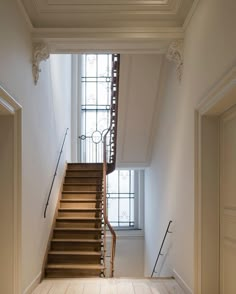 an empty staircase leading up to a large window