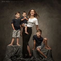 a woman and three children posing for a photo in front of a dark background with the caption piccolia photography