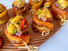 small appetizers are arranged on a plate with toothpicks