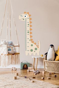 a child's room with toys and wall decals in the shape of a giraffe