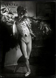 an old black and white photo of a man dressed as a clown