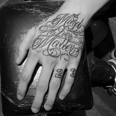 a person with a tattoo on their hand