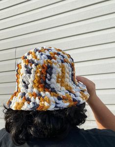 a person wearing a multicolored crocheted hat