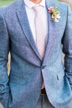 a man in a blue suit and pink tie