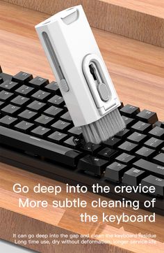 the keyboard is being cleaned with a micro scruber on it's side and an ad that says go deep into the crevic more subtle cleaning of the keyboard