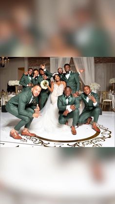 a group of men and women in green suits posing for a photo on the dance floor