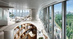 the interior of an office building with large windows and a spiral staircase leading up to it