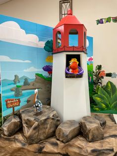 there is a small red and white lighthouse on display in the children's room