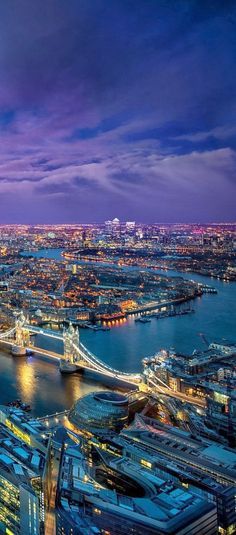 an aerial view of london at night with the shard tower in the foreground