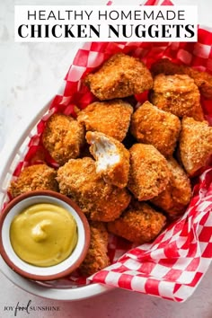 chicken nuggets in a basket with mustard and ketchup