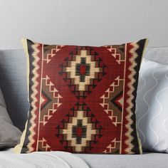 a red and beige pillow on a couch