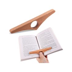 a wooden book holder with an open book in front of it and a hand holding the book