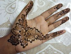 a person's hand with henna tattoos on it