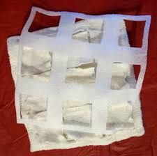 a piece of white paper sitting on top of a red cloth