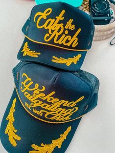 Show off your vibes in our new 90's inspired Eat The Rich trucker hat.- Features the phrase "Eat The Rich" all in a gold puff ink - Comes with a small detachable pin on each hat - Individually heat pressed onto each hat- 5 Panel, Mesh Back with Snap Back*due to screens & filters colors may vary slightly to photos* Graphic Baseball Cap, Futch Style, Street Wear Hats, Artist Merch, Streetwear Hats, 90s Sports, Eat The Rich, Embroidered Leaves, Vintage Trucker Hats