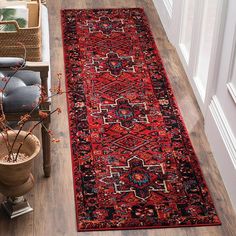 a red rug on the floor in a hallway