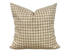 a brown and white checkered pillow on a white background