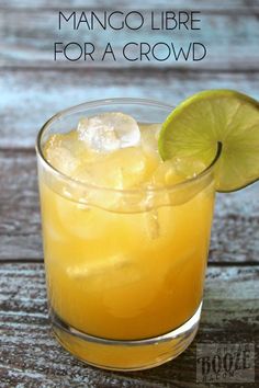 a glass filled with orange juice and lime