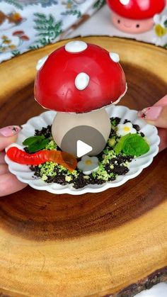 a person holding a plate with a mushroom on it and vegetables in the bowl next to it