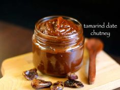 a jar of date chutney on a cutting board