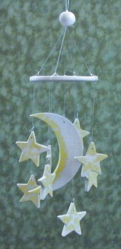 a mobile with stars and moon hanging from it