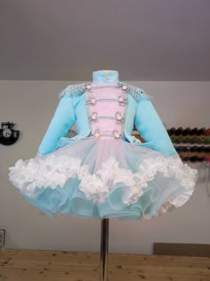 a dress made out of tulle and laces on a mannequin stand