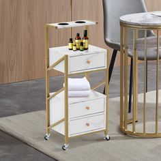 a white and gold side table with bottles on it