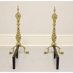 a pair of brass candlesticks on stands