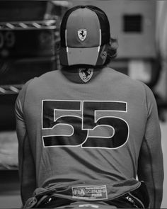 the back of a man wearing a hat and number 55 on his t - shirt