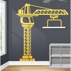 a room with a ceiling fan and a crane on the wall