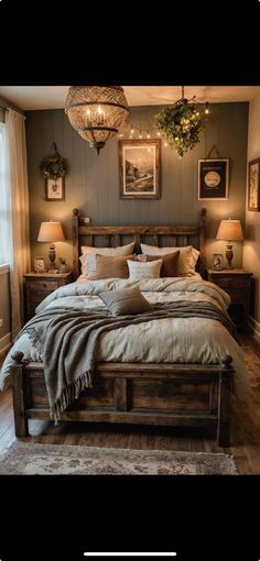 a large bed sitting in a bedroom next to two lamps and pictures on the wall