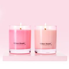 two candles sitting side by side in front of a pink background with the words glitter bomb on it