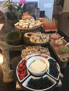 a table topped with lots of different types of snacks and desserts on top of it