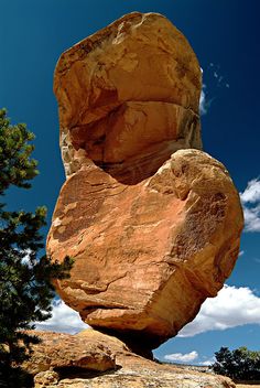 a large rock formation in the middle of a field