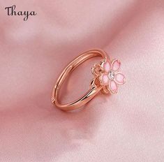 Capture the essence of cherry blossom season with our Silver Sakura Spinner Ring. This elegant piece tells a story of beauty and renewal, as delicate petals bloom and dance in the breeze. The spinner design allows for a soothing sensation, perfect for those seeking balance and serenity in their daily lives. Elevate your style with this stunning symbol of hope and new beginnings.   - Brand: Thaya  - Material: S925 Silver  - Weight : About 2.34g  - Size: Stack Mouth 14th  - Style: Flower  - Gender: Women Rose Gold Jewelry For Anniversary In Spring, Rose Gold Jewelry For Spring Anniversary, Rose Gold Ring For Spring, Spring Rose Gold Ring Jewelry, Spring Rose Gold Flower Jewelry, Spring Wedding Rose Gold Flower Ring, Delicate Flower Ring For Spring, Feminine Blossom Jewelry For Spring, Delicate Spring Flower Ring