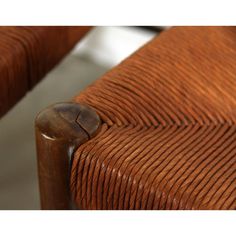 a close up view of the back of a brown leather chair with wooden armrests