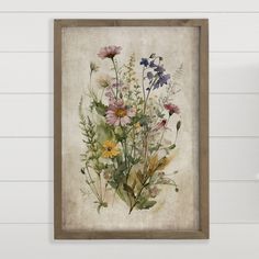 a painting hanging on the wall with flowers in it