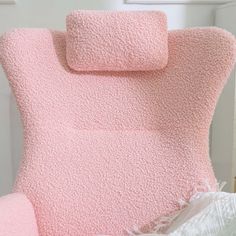 a bed with pink sheets and pillows on top of it