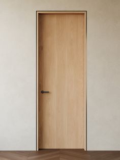 an empty room with a wooden door and hard wood floor