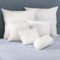 white pillows and pillow cases on a bed