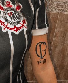 a woman's arm with a tattoo on it and the letter q in black ink