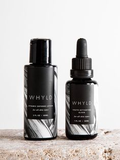 two bottles of whyld sitting on top of a stone counter next to each other