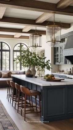 a large kitchen with an island in the middle and lots of seating around it,