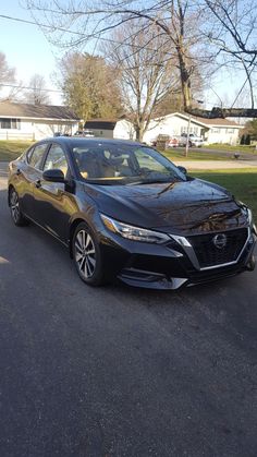 a black car is parked on the street