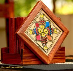 a wooden box with an intricate design on the front and sides, sitting on top of a table