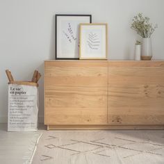 a wooden cabinet sitting on top of a white rug