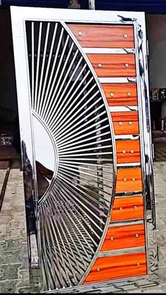 an orange and white fan sitting on top of a sidewalk