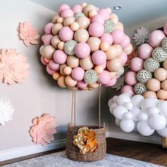 the balloon wall is decorated with pastel pinks, white and gold balloons in an elegant setting