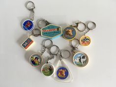 a bunch of different key chains with some pictures on them